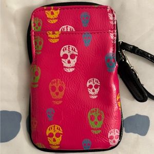Stylish pink wallet with various colored skulls